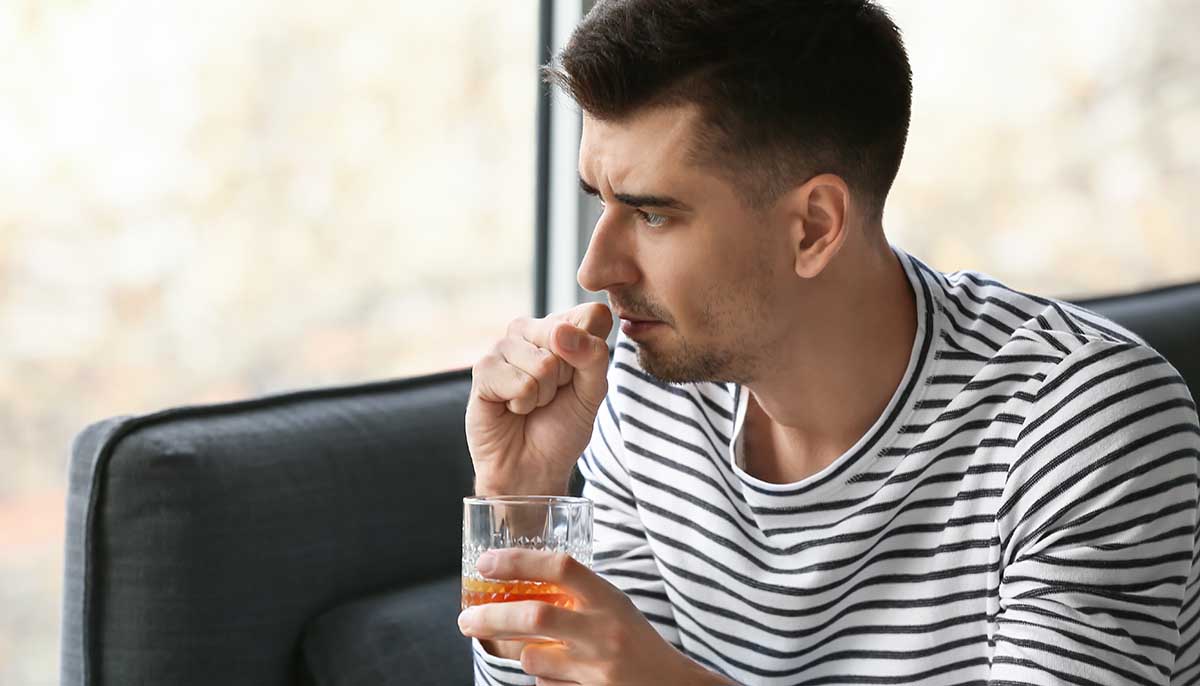 pensive man drinking alone