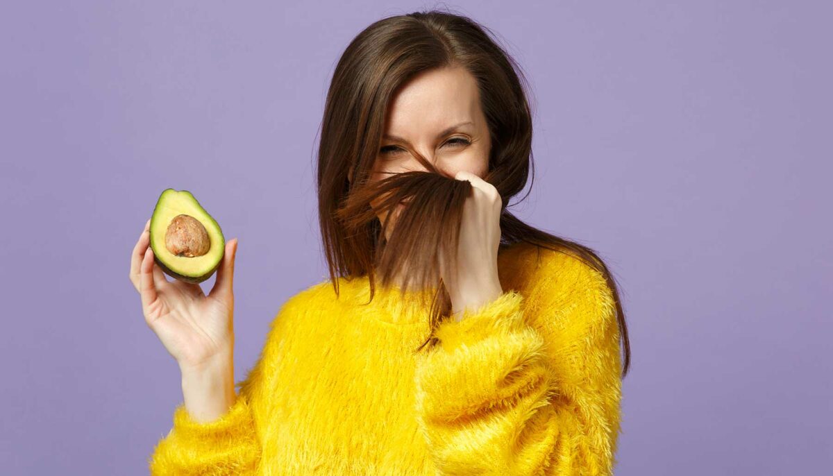 Woman admiring her hair after applying an avocado hair mask